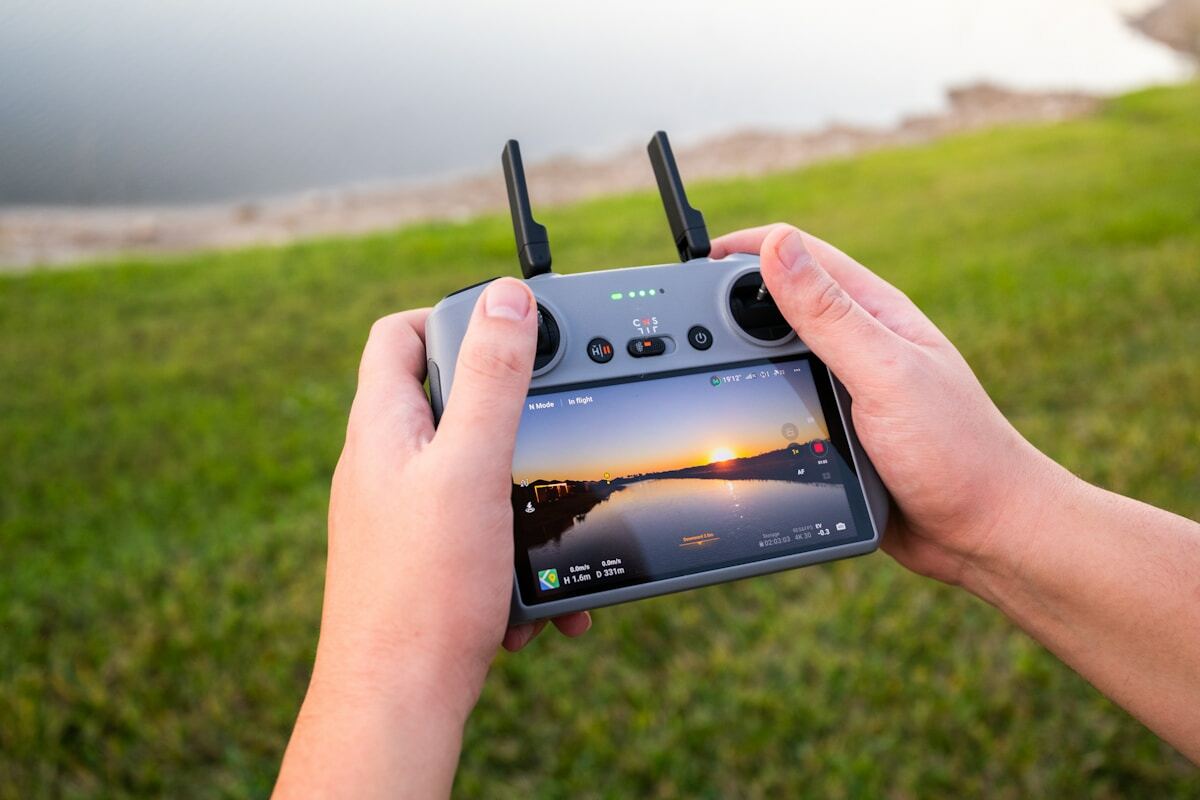 A person holding a small device in their hands