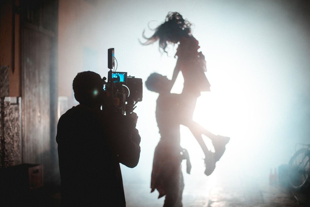 a person holding a camera in the air