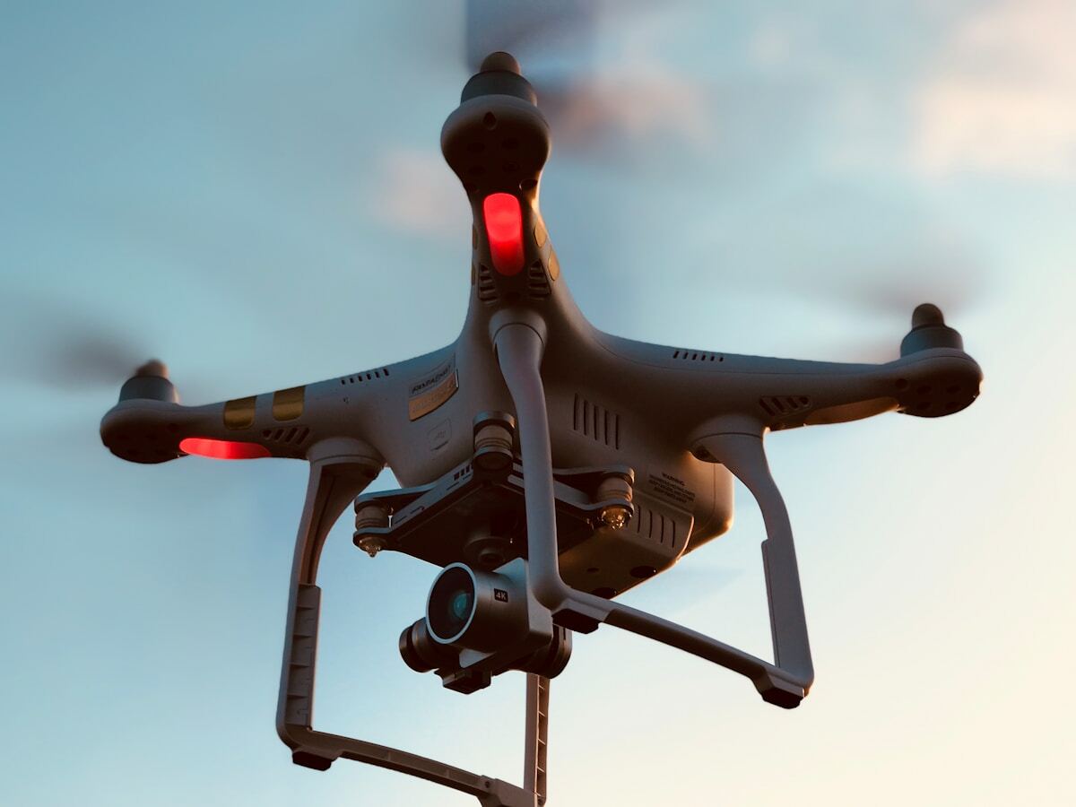 Drone volant avec caméra et feux rouges.